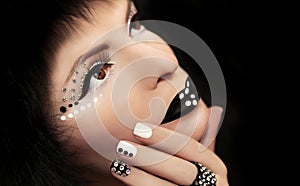 Makeup and manicure with rhinestones. photo