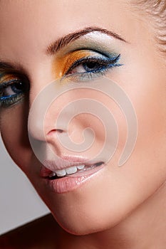 Makeup is my art and the face is my canvas. Close up portrait of a beautiful woman with yellow and green eyeshadow on.