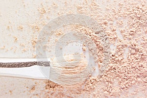 Makeup powder and white cosmetic brush. Light nude color matte foundation powder texture