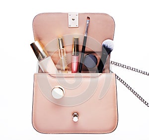 Makeup products with cosmetic bag on white background