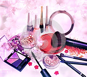 Makeup products and jewelry on floral background