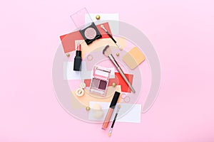 Makeup products on pink background. Top view