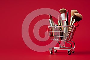 Makeup products in shopping cart on red background. Lipstick, mascara, lip gloss, brushes, nail polish. Shopping cart full of