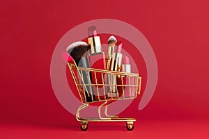 Makeup products in shopping cart on red background. Lipstick, mascara, lip gloss, brushes, nail polish. Shopping cart full of