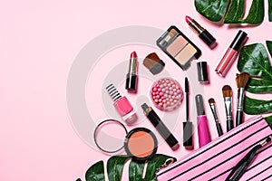 Makeup professional cosmetics on pink background.