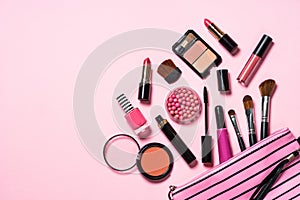 Makeup professional cosmetics on pink background.