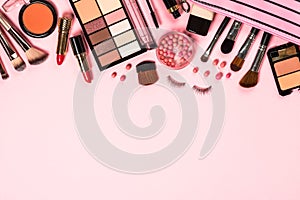 Makeup professional cosmetics on pink background.