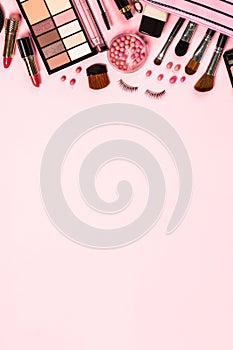 Makeup professional cosmetics on pink background.