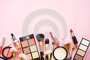 Makeup professional cosmetics on pink background.