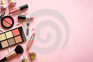 Makeup professional cosmetics on pink background.