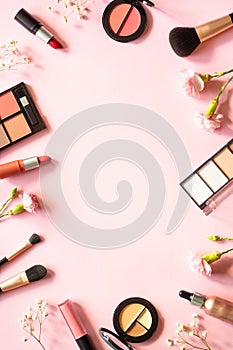 Makeup professional cosmetics on pink background.