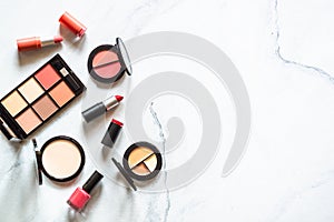 Makeup professional cosmetics on white marble background.