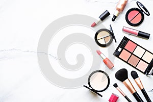 Makeup professional cosmetics on white marble background.