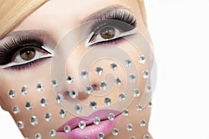 Makeup with rhinestones.