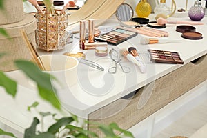 Makeup room. Different beauty products on dressing table indoors, closeup