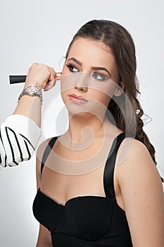 Makeup session with beautiful young brunette woman. Portrait of attractive woman isolated on white. Closeup portrait of a woman