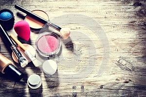 Makeup set with various cosmetic products and brushes. Beauty background