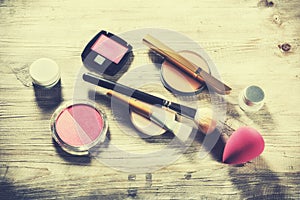 Makeup set with various cosmetic products and brushes. Beauty background