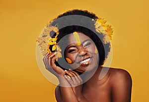 Makeup, sunflower and portrait of black woman in studio for beauty, creative or spring. Natural, cosmetics and floral