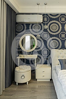 Makeup table and oval mirror in bedroom