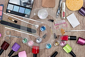 Makeup tools on a wooden background.