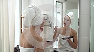 Makeup. Woman Applying Eyeshadows And Looking At Mirror
