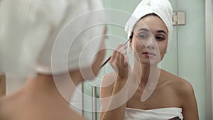 Makeup. Woman Applying Eyeshadows And Looking At Mirror
