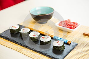 Maki roll with salmon, popular Japanese cuisine. Sushi roll with fish, cream cheese and vegetables