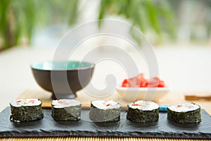 Maki roll with salmon, popular Japanese cuisine. Sushi roll with fish, cream cheese and vegetables