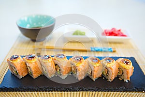 Maki roll with salmon, popular Japanese cuisine. Sushi roll with fish, cream cheese and vegetables