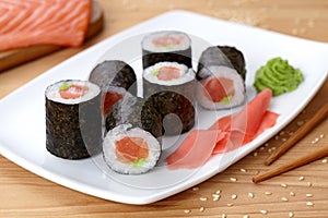 Maki sushi roll with salmon, wasabi, ginger and