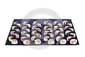 Maki Sushi set Futomaki rolls with fresh ingredients. Rolls on black stone isolated on white background. Sushi menu