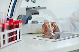 Making advances in the health sciences. Closeup shot of a female scientist recording her findings on a digital tablet.