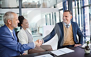 Making all the right connections. businesspeople shaking hands during a boardroom meeting.