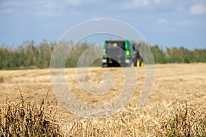 making bales tractor working in rice harvest season