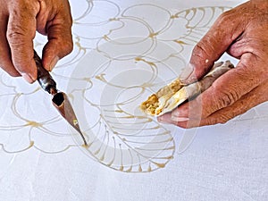 Making batik by drawing beautiful patterns by hand