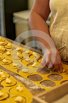 Making and bending tortellini in the traditional italian way by