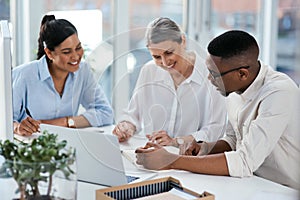 Making big plans to propel their business. a group of businesspeople working together in an office.