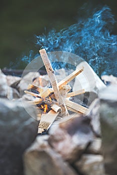 Making a bonfire: Small flame on a camping trip, adventure outdoors