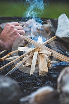 Making a bonfire: Small flame on a camping trip, adventure outdoors photo