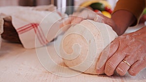 Making bread - woman hands kneading the dough