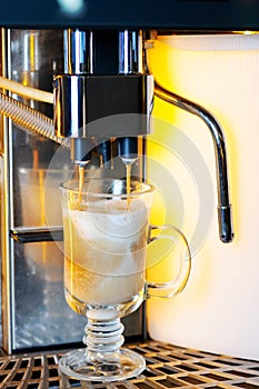 Making capuchino in coffee machine photo