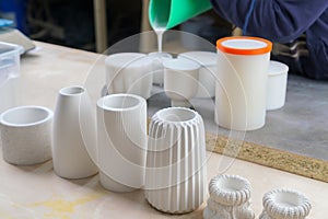 Making and casting decorative dishes and vases from plaster for home decoration in the workshop.