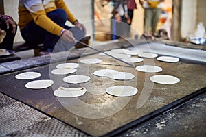 Making of chapati round flatbreads for langar in sikh gurudwara temple many uncooked roti flatbreads