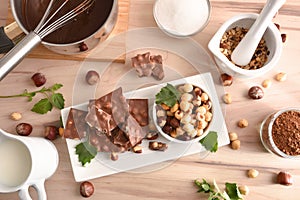 Making chocolate with hazelnuts on a wooden kitchen bench