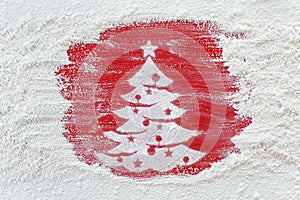 Making christmas cookies concept - xmas tree drawing in flour on