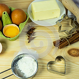 Making Christmas cookies on rustic wooden table. Ingredients for baking a cake cookies or sweet pastry on wooden table background