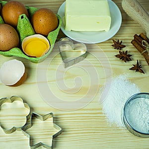 Making Christmas cookies on rustic wooden table. Ingredients for baking a cake cookies or sweet pastry on wooden table background