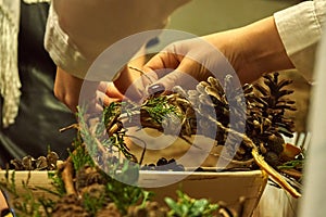 Making a Christmas wreath girl close-up