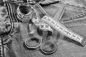 Making clothes and design concept. Measure tape wound around metal scissors as making clothes concept